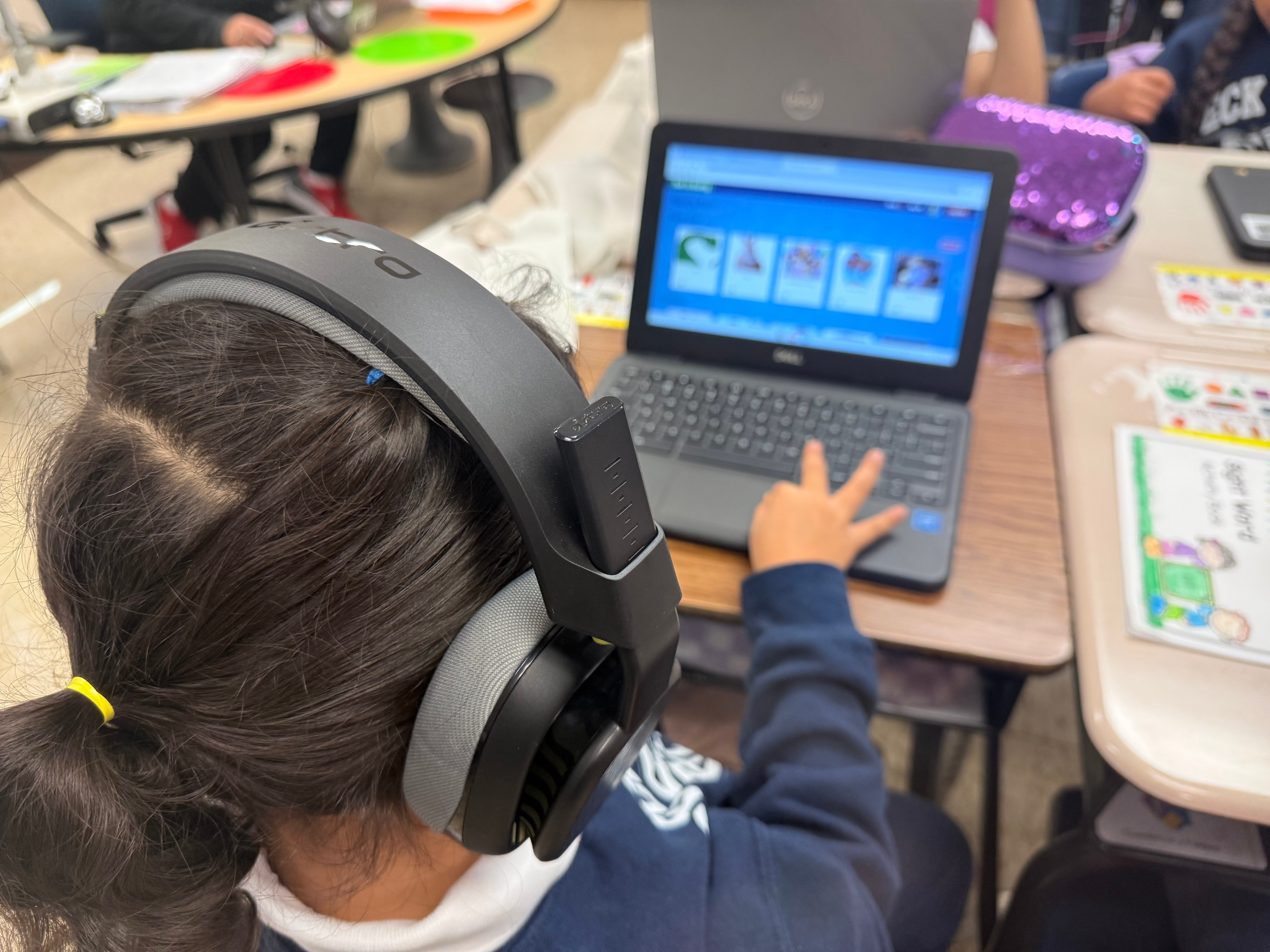 A student at Peck Elementary School in Chicago uses donated headphones from Logitech